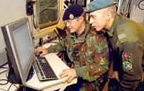 A member of 14 Geographical Squadron, Royal Engineers instructing a member of the Danish Army to use current mapping software, during Exercise ARRCADE Fusion 04