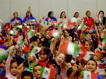 Children wave Mexican flags